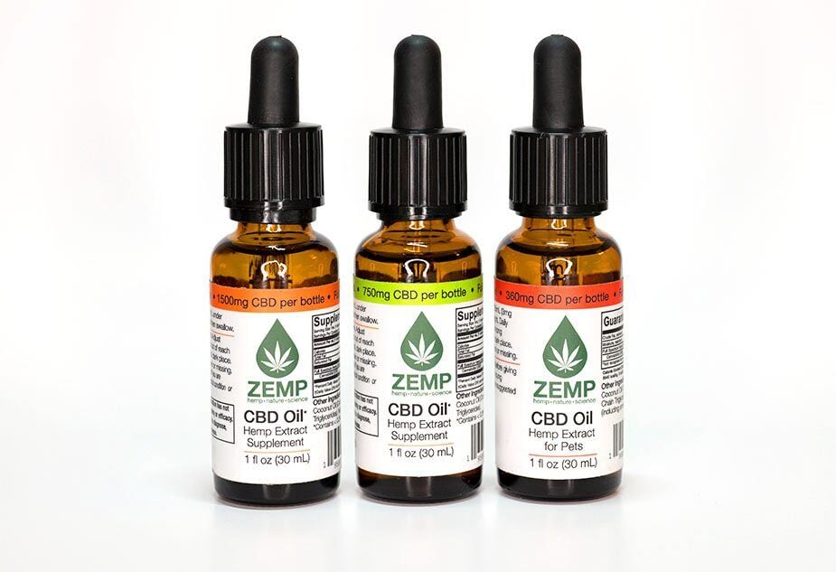 Three Zemp Hemp CBD supplement bottles on a white background.